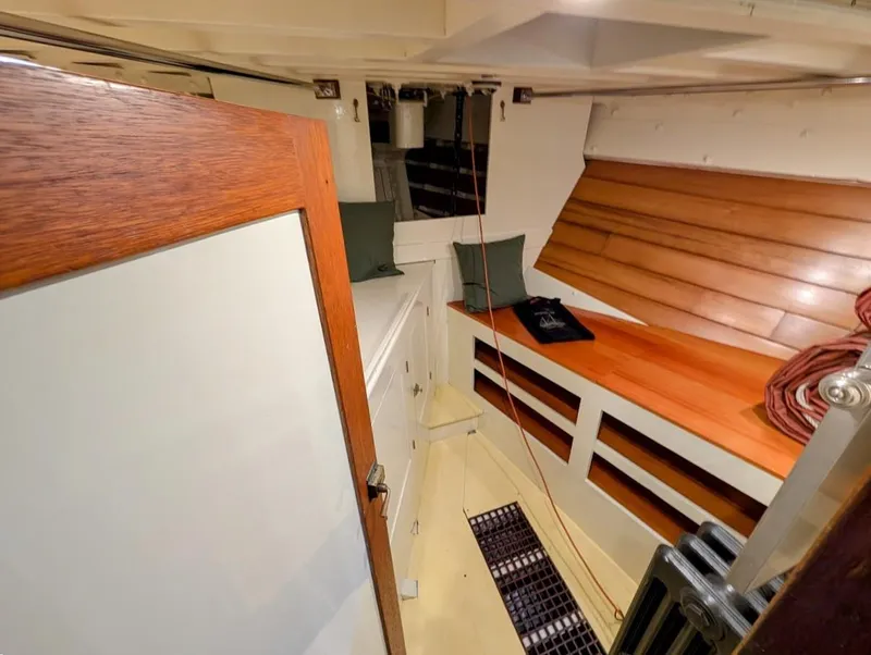 Slide: The Image of Interior of a 1936 Classic Motorsailer with wooden paneling and cozy seating area. - 33