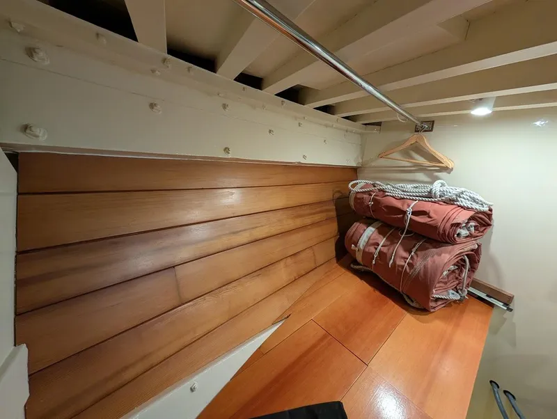 Slide: The Image of 1936 Classic Motorsailer interior with wooden paneling and neatly stored sails. - 35