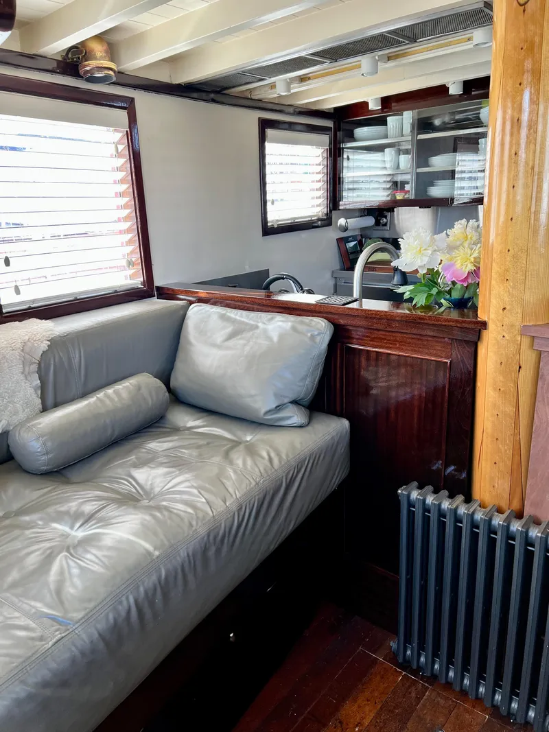 Slide: The Image of Interior of a 1936 Classic Motorsailer with leather seating and wooden accents. - 42