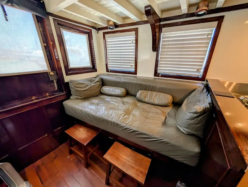 Slide: The Image of Interior of a 1936 Classic Motorsailer with leather seating and wooden accents. - 43