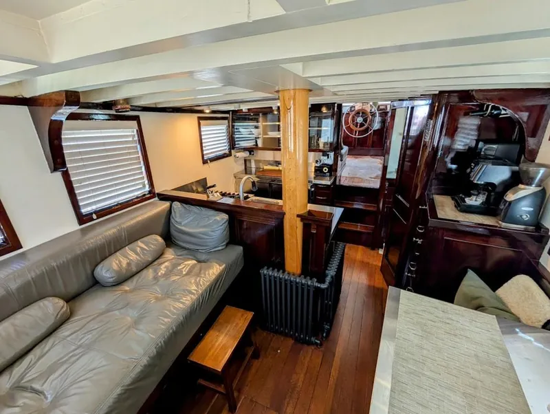 Slide: The Image of Interior of a 1936 Classic Motorsailer with wooden furnishings and cozy seating area. - 44