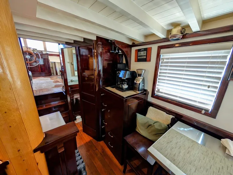 Slide: The Image of Interior of a 1936 Classic Motorsailer with wooden furnishings and cozy seating area. - 45