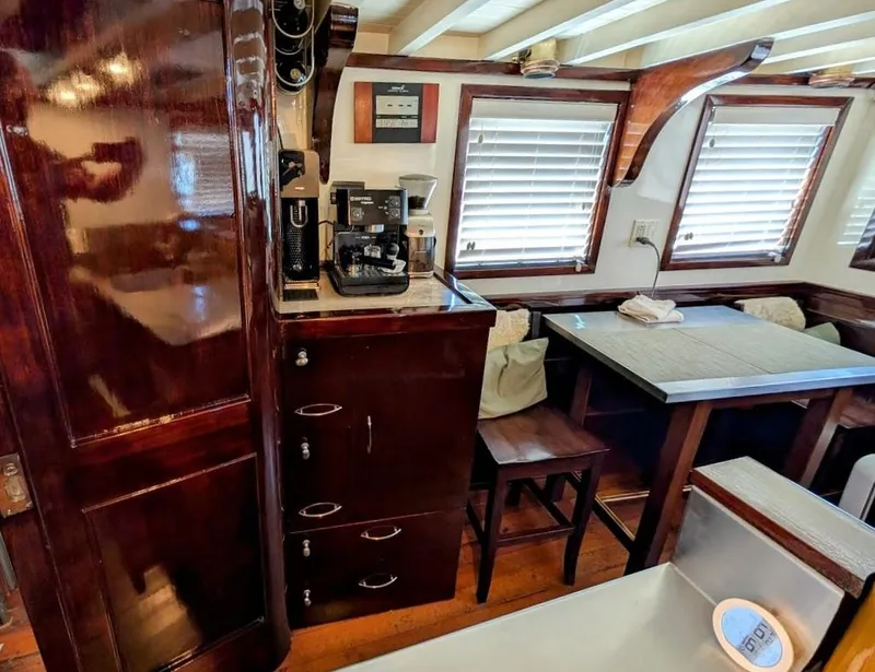 Slide: The Image of Interior of a 1936 Classic Motorsailer with wooden cabinetry and dining area. - 46