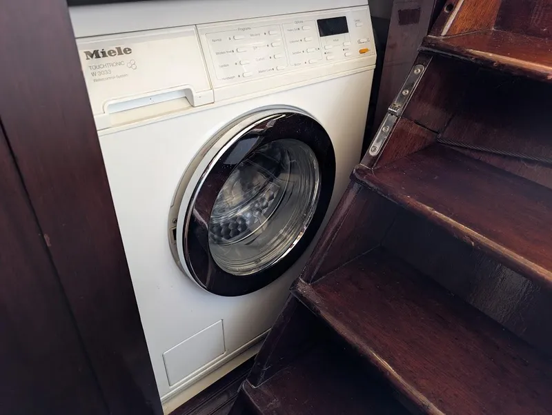 Slide: The Image of Washing machine beside wooden stairs on a 1936 Classic Motorsailer. - 47