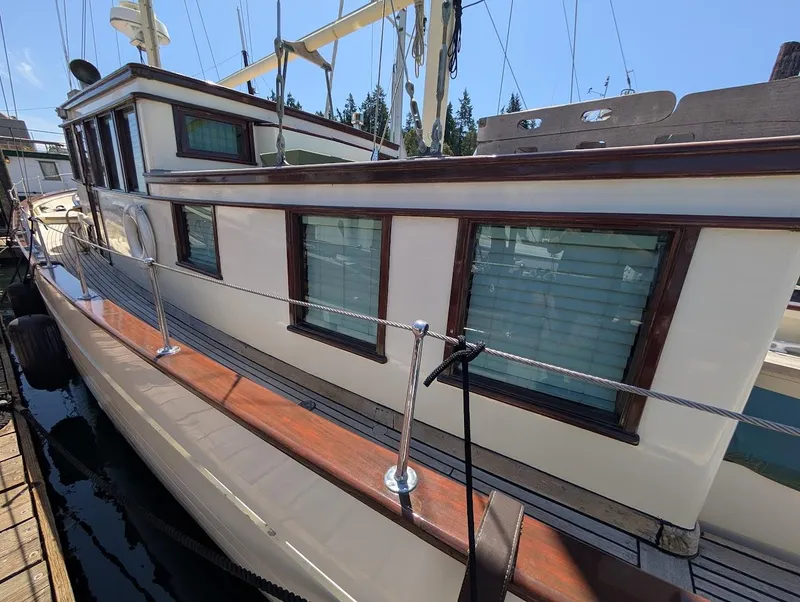 Slide: The Image of Classic 1936 Motorsailer with wooden deck and cabin, docked at marina. - 5