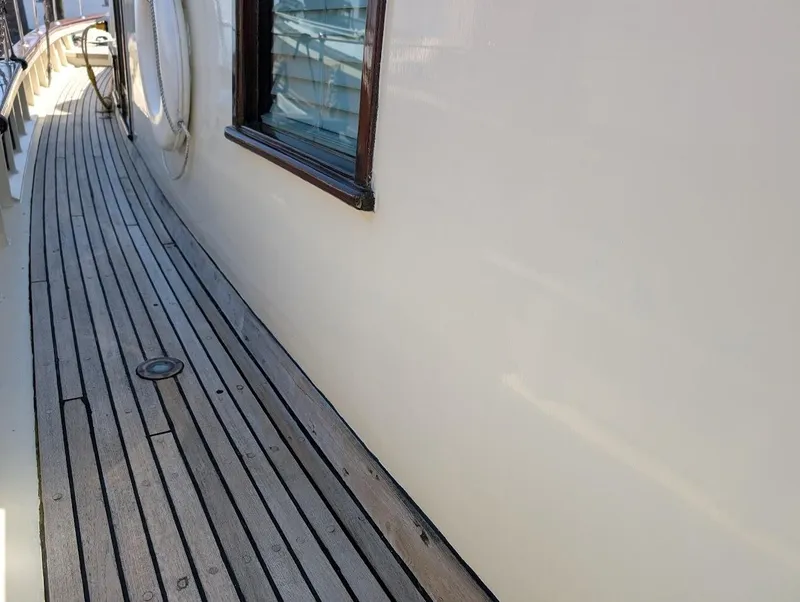 Slide: The Image of Classic 1936 Motorsailer with wooden deck and white hull, showcasing vintage nautical design. - 9