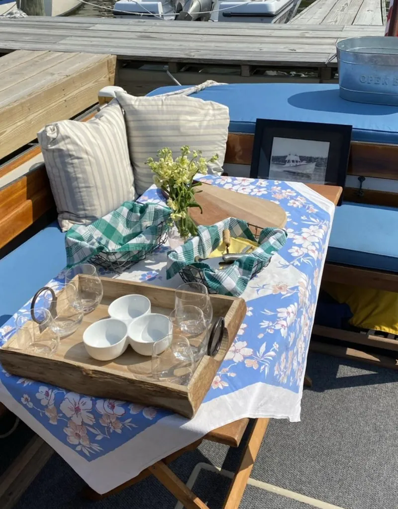 Slide: The Image of 1959 Goudy & Stevens Flybridge Cruiser with a cozy outdoor dining setup on deck. - 13