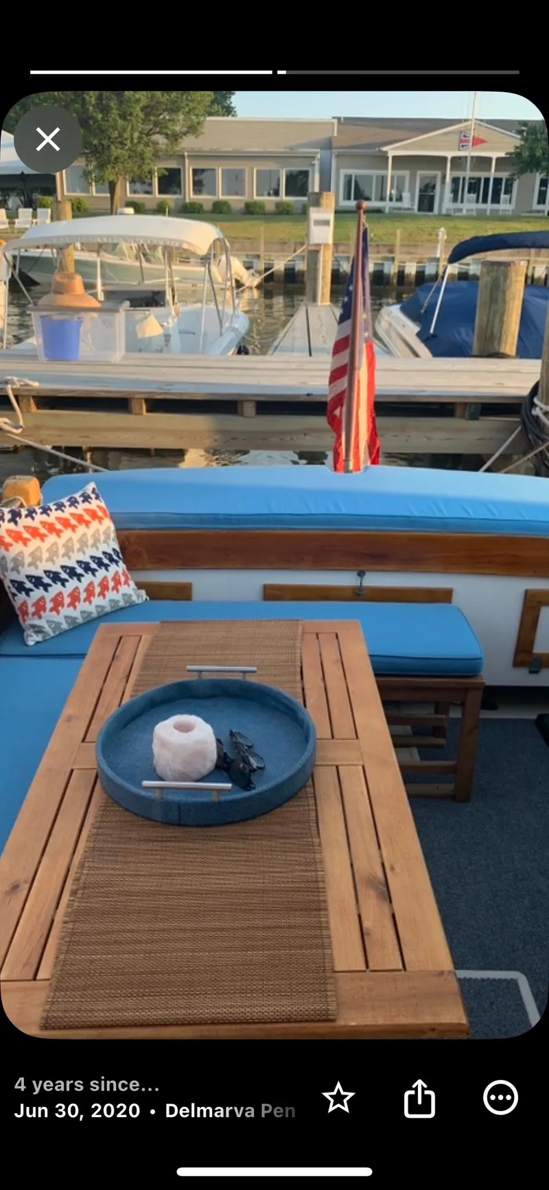 Slide: The Image of 1959 Goudy & Stevens Flybridge Cruiser with wooden deck, docked at marina, featuring outdoor seating. - 14