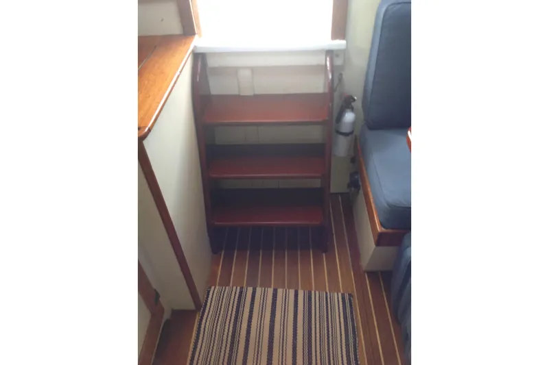 Slide: The Image of 1959 Goudy & Stevens Flybridge Cruiser interior with wooden steps and striped rug. - 19