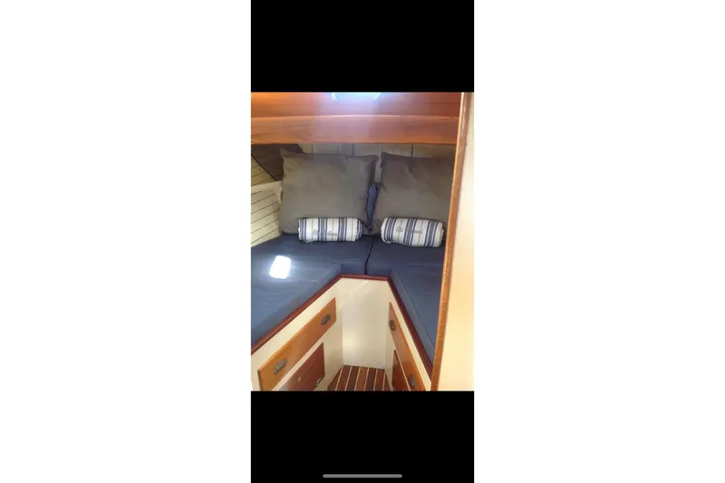Slide: The Image of 1959 Goudy & Stevens Flybridge Cruiser cabin with cozy bedding and wooden interior. - 29
