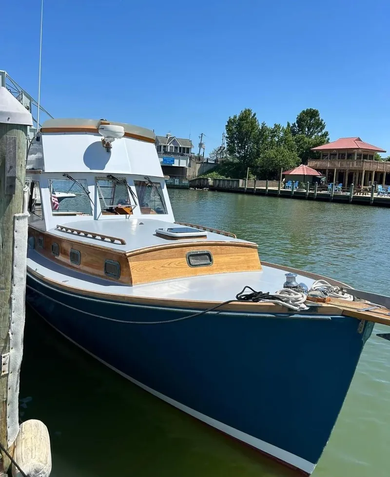 Slide: The Image of 1959 Goudy & Stevens Flybridge Cruiser docked by waterfront homes. - 3