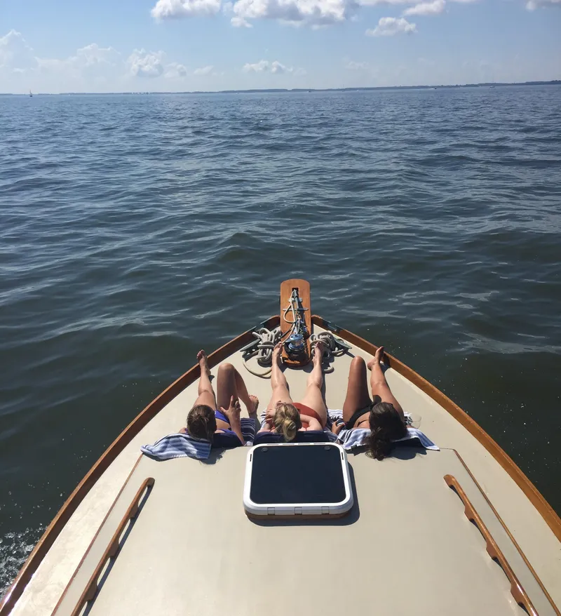 Slide: The Image of Three people relaxing on a 1959 Goudy & Stevens Flybridge Cruiser at sea. - 4