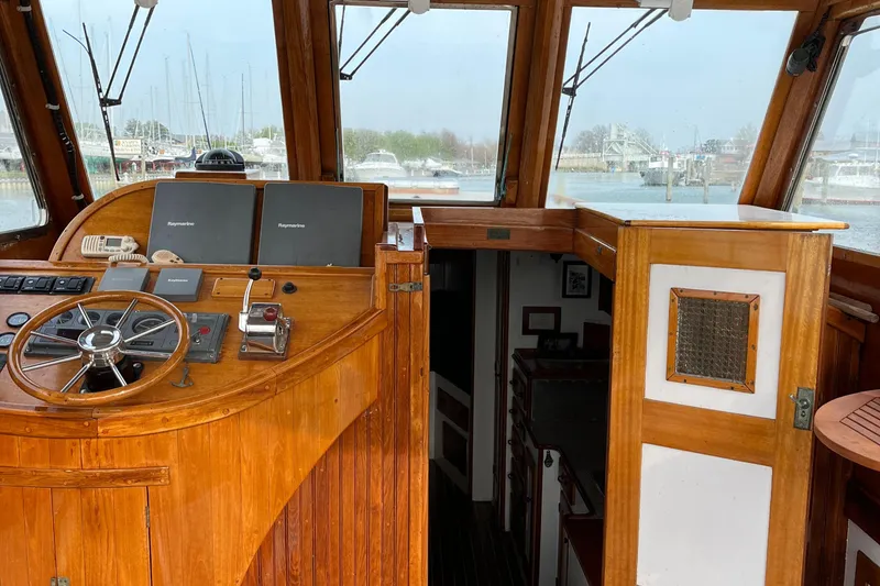 Slide: The Image of 1959 Goudy & Stevens Flybridge Cruiser helm with wooden interior and navigational equipment. - 8