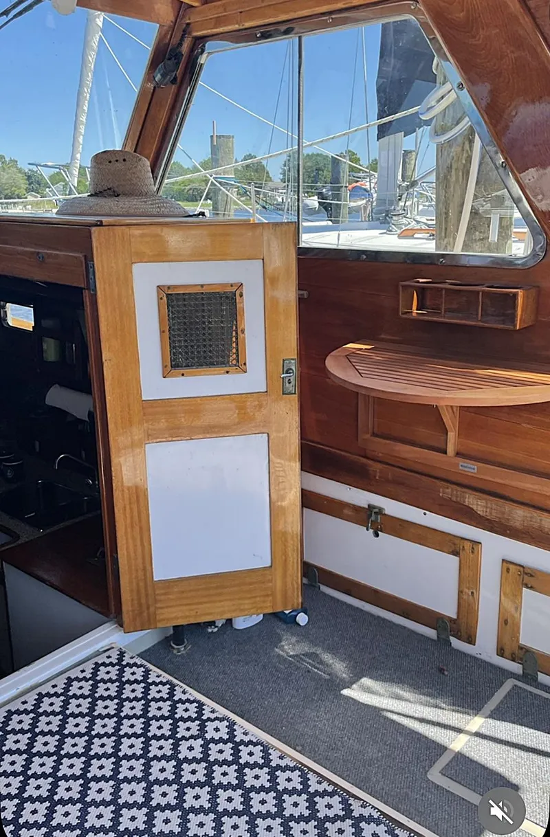 Slide: The Image of 1959 Goudy & Stevens Flybridge Cruiser interior with wooden accents and nautical decor. - 9
