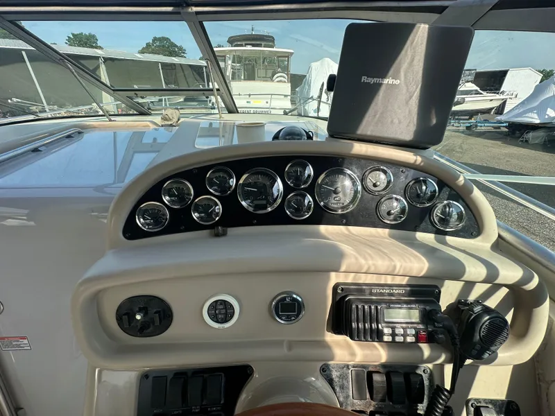 Slide: The Image of 1998 Sea Ray 290 Sundancer dashboard with gauges and navigation equipment. - 13