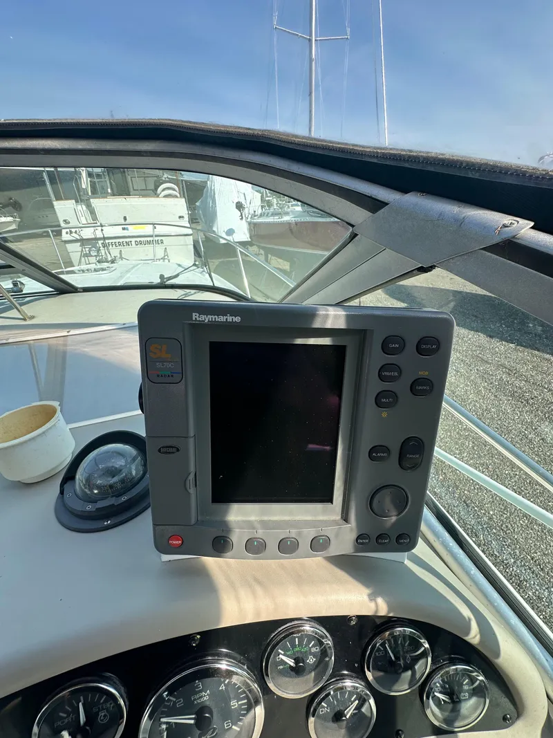 Slide: The Image of 1998 Sea Ray 290 Sundancer dashboard with Raymarine navigation system and gauges. - 15