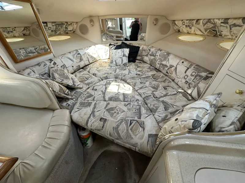 Slide: The Image of 1998 Sea Ray 290 Sundancer cabin interior with patterned upholstery and cozy seating area. - 20