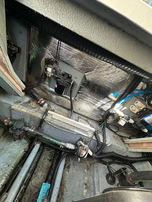 Slide: The Image of Engine compartment of a 1998 Sea Ray 290 Sundancer boat, showing wiring and components. - 27