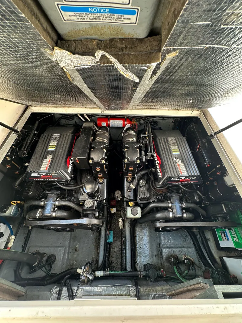 Slide: The Image of Engine compartment of a 1998 Sea Ray 290 Sundancer boat, showcasing dual engines. - 28