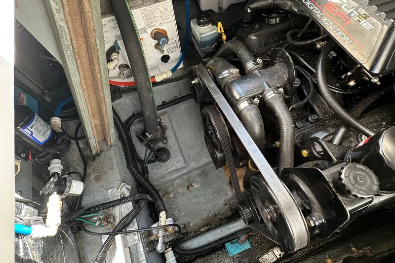 Slide: The Image of Engine compartment of a 1998 Sea Ray 290 Sundancer boat, showing mechanical components and wiring. - 29