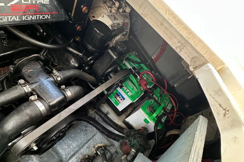 Slide: The Image of Engine compartment of a 1998 Sea Ray 290 Sundancer with visible battery and ignition system. - 30