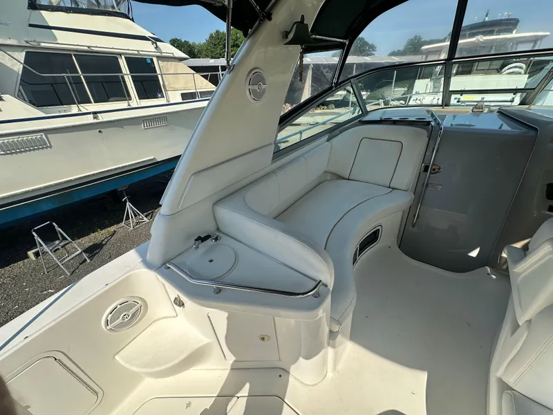 Slide: The Image of 1998 Sea Ray 290 Sundancer boat interior with white seating and dashboard. - 9
