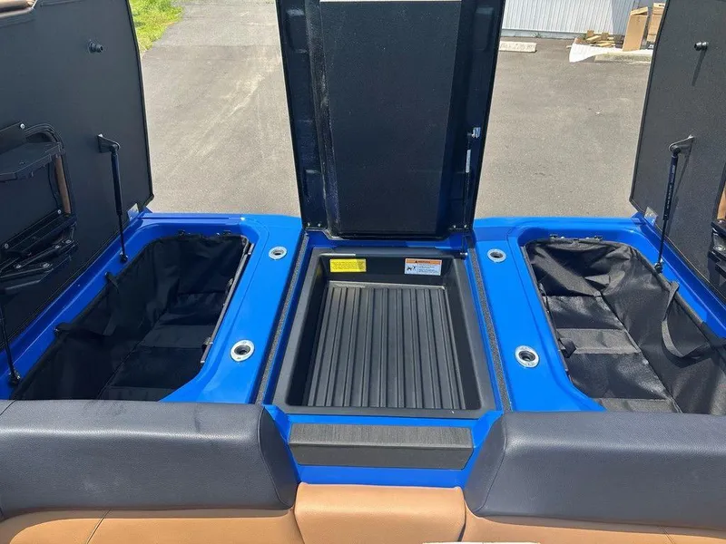 Slide: The Image of 2025 Moomba Tykon boat storage compartments with open hatches, showcasing spacious interior. - 10