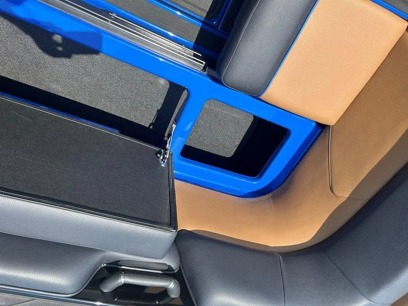 Slide: The Image of 2025 Moomba Tykon interior with blue and tan seating, showcasing modern design. - 13