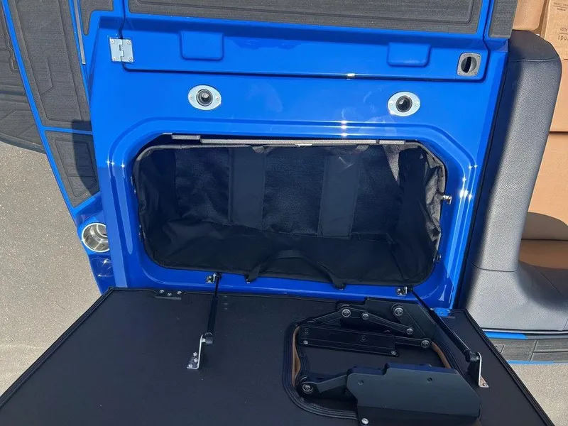 Slide: The Image of 2025 Moomba Tykon blue vehicle trunk with open storage compartment. - 14