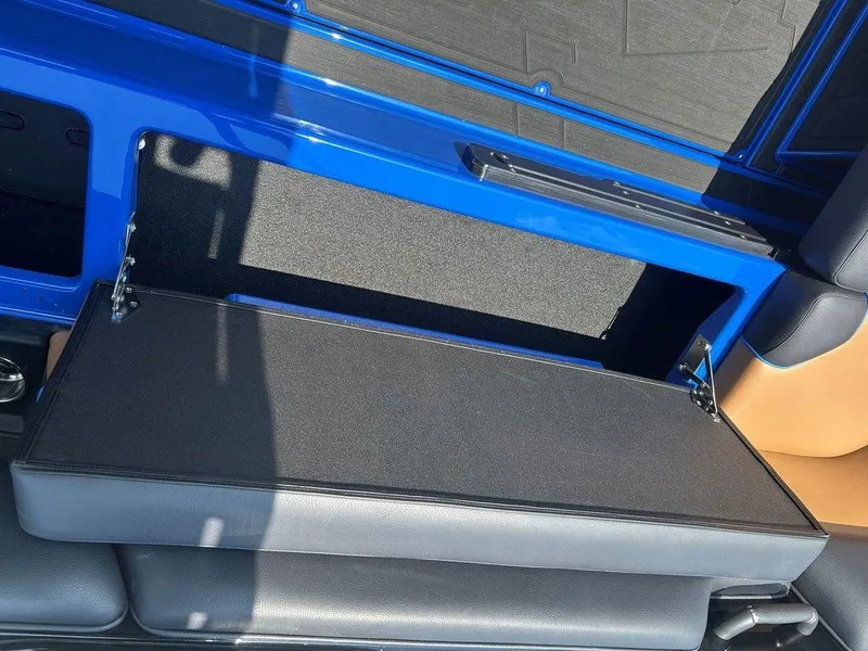 Slide: The Image of 2025 Moomba Tykon interior storage compartment with blue and black design. - 17