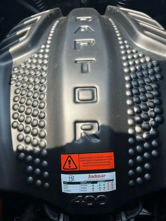 Slide: The Image of 2025 Moomba Tykon engine cover with "Raptor" branding and safety label. - 19