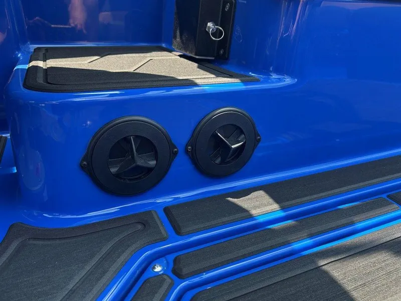 Slide: The Image of 2025 Moomba Tykon boat interior with blue and black detailing, featuring dual circular vents. - 20