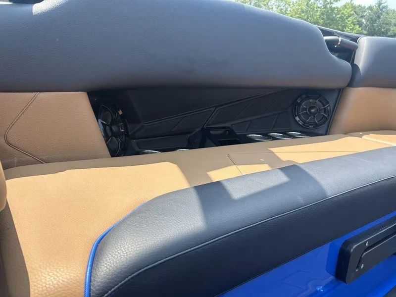 Slide: The Image of 2025 Moomba Tykon interior with tan and black seating, featuring built-in speakers. - 21