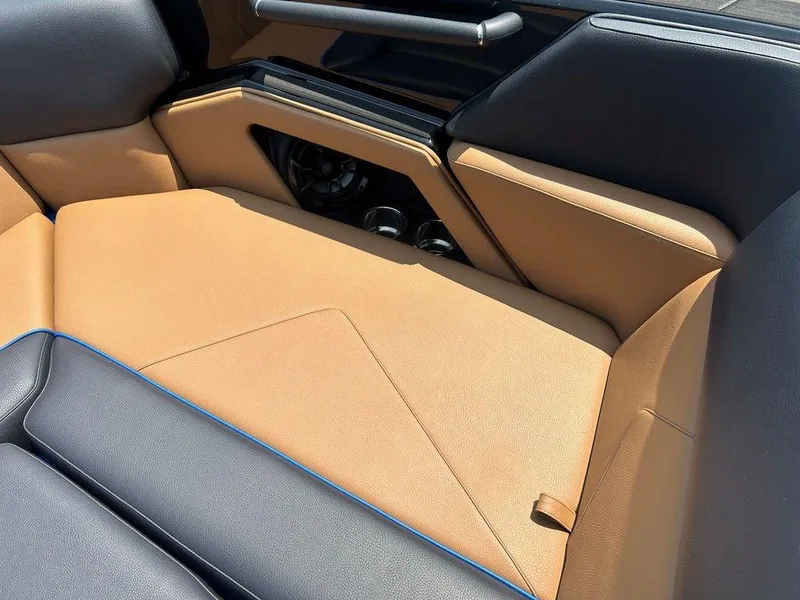 Slide: The Image of 2025 Moomba Tykon interior with tan and black seating, featuring sleek design and modern accents. - 26