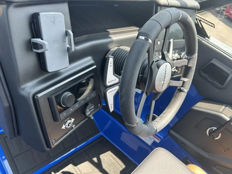 Slide: The Image of 2025 Moomba Tykon dashboard with steering wheel and control panel. - 39