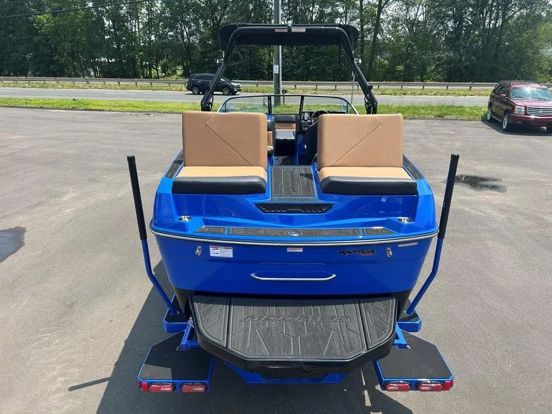 Slide: The Image of 2025 Moomba Tykon boat, blue exterior, tan seats, parked outdoors. - 41