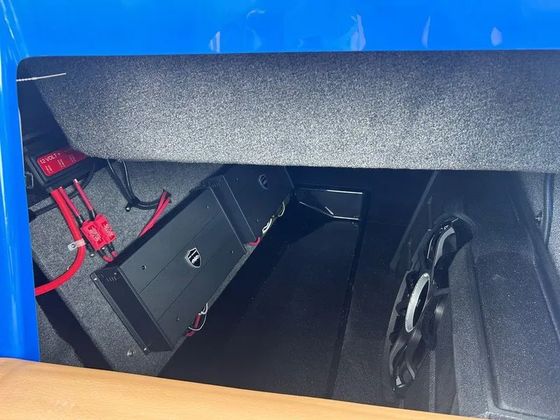 Slide: The Image of 2025 Moomba Tykon interior storage with audio equipment and wiring. - 9