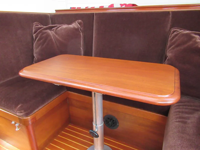 Slide: The Image of Vintage 1970 Sparkman and Stephens yacht interior with wooden table and plush seating. - 11