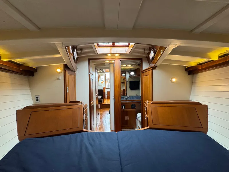 Slide: The Image of Interior of 1970 Custom Sparkman and Stephens yacht, featuring wooden cabinetry and cozy sleeping area. - 15