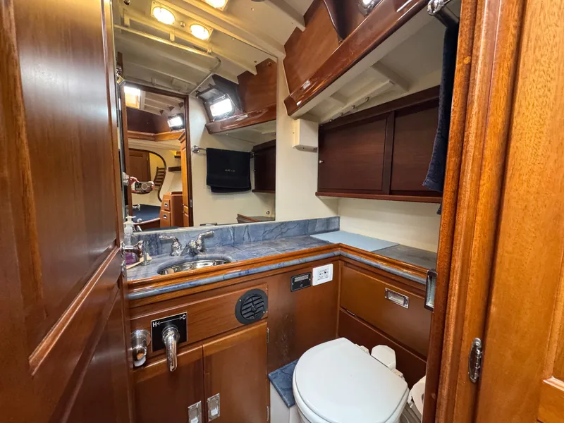 Slide: The Image of 1970 Sparkman and Stephens yacht bathroom with wooden cabinetry and modern fixtures. - 16