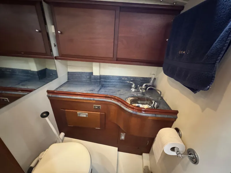 Slide: The Image of 1970 Custom Sparkman and Stephens yacht bathroom with wooden cabinets and compact sink. - 17