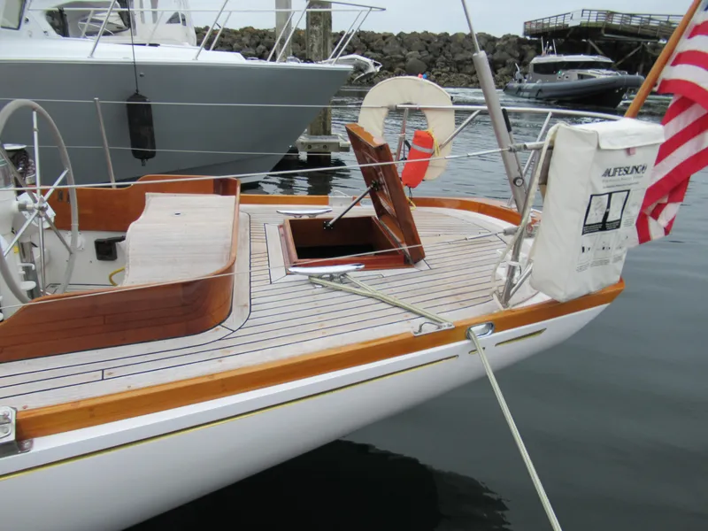 Slide: The Image of 1970 Custom Sparkman and Stephens yacht with wooden deck and American flag at marina. - 18