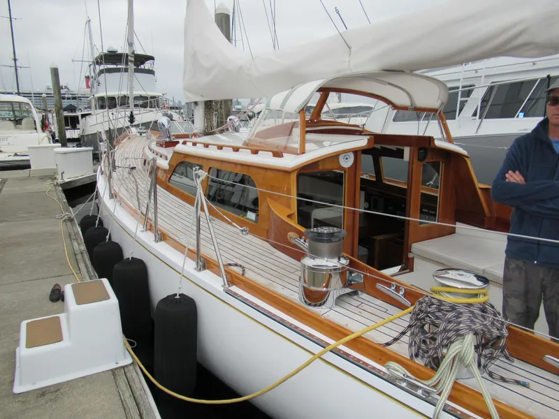 Slide: The Image of 1970 Custom Sparkman and Stephens sailboat docked at marina, featuring wooden deck and classic design. - 19