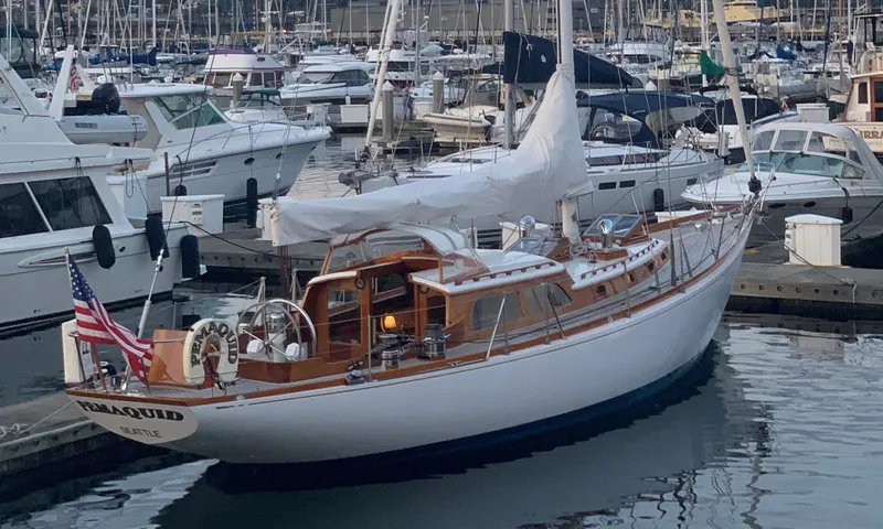 Slide: The Image of Vintage 1970 Sparkman and Stephens sailboat docked in a marina, featuring classic wooden design. - 2