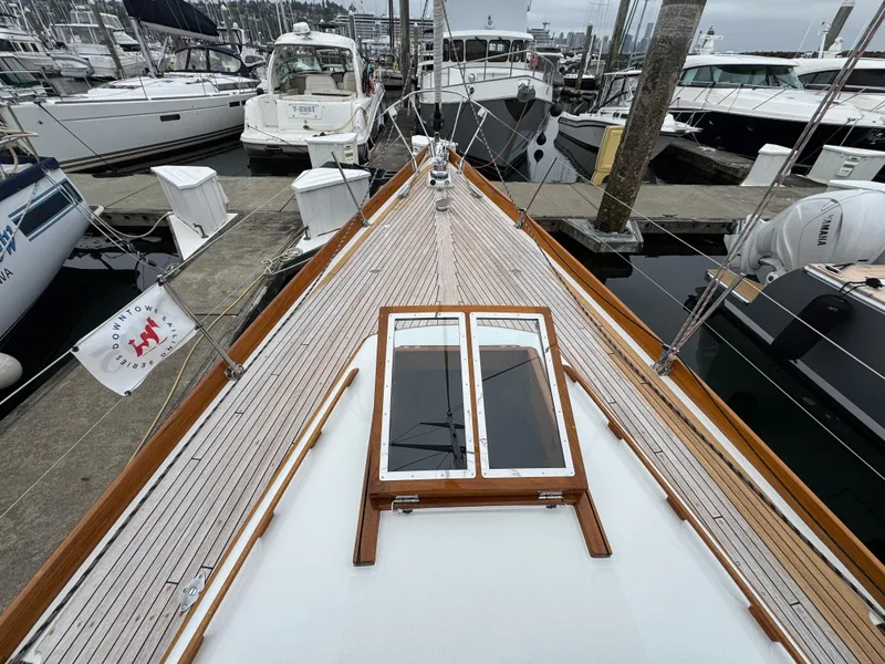 Slide: The Image of 1970 Custom Sparkman and Stephens yacht docked at marina, showcasing wooden deck and hatch. - 21