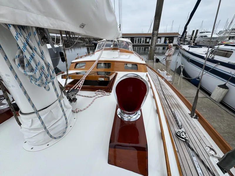 Slide: The Image of 1970 Custom Sparkman and Stephens sailboat docked, showcasing polished wood and rigging details. - 23