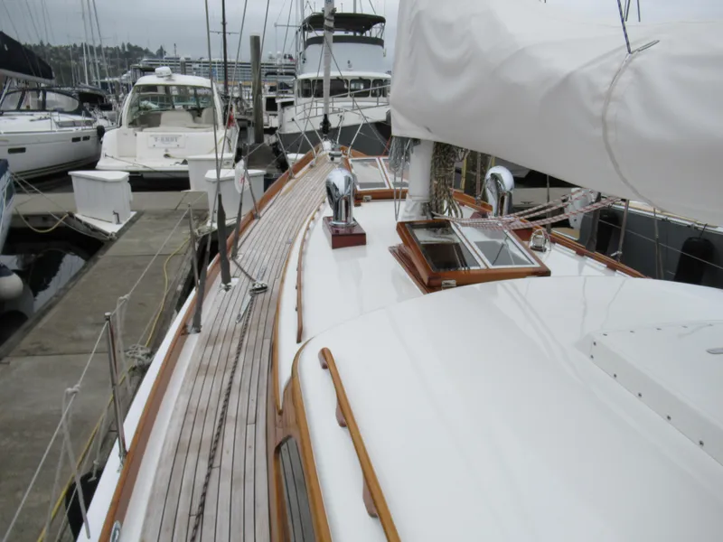 Slide: The Image of 1970 Custom Sparkman and Stephens yacht docked at marina, showcasing sleek deck design. - 24