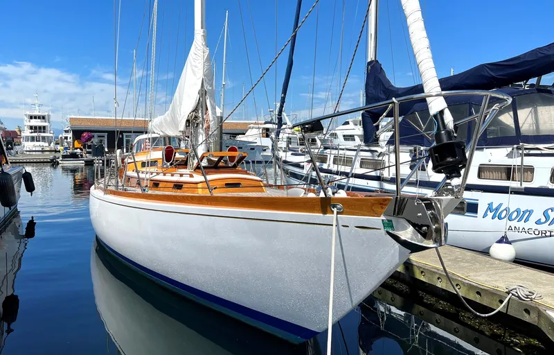 Slide: The Image of Vintage 1970 Sparkman and Stephens sailboat docked in a marina under clear blue skies. - 26