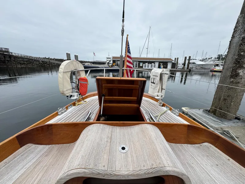 Slide: The Image of 1970 Custom Sparkman and Stephens yacht docked at a marina, featuring wooden deck and American flag. - 28