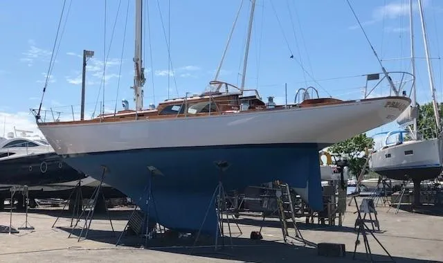 Slide: The Image of 1970 Custom Sparkman and Stephens sailboat on dry dock, blue hull, wooden deck. - 31
